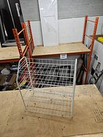 front view of white metal wire rack showing three tiers