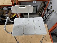 Full view of bench showing seat panels, frame, legs, and backrest