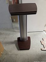 Front view showing wood top, aluminum column, wood base