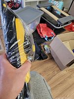 Yellow and black spin mop head in plastic