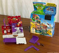 Playset assembled with accessories laid out and original box