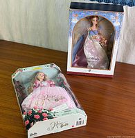 Both boxed Barbie dolls on tabletop