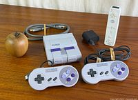 All included items laid out: SNES Classic console, two controllers, HDMI cable, USB power adapter, Wii Remote