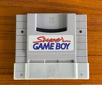 Front view of Nintendo Super Game Boy cartridge with dust cover attached
