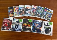 All twelve Wii game cases laid out in two rows