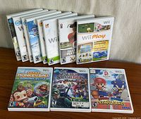 All ten Wii game cases displayed, three front covers and seven standing, showing completeness and condition