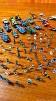 Group of miniature soldiers, tanks, armoured vehicles and aircraft on tabletop