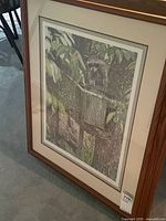 Full view of framed print showing raccoon image, matting and frame