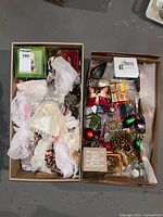 Two boxes filled with assorted Christmas decorations