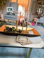 Overall lot: 4 champagne flutes on gold tray, stack of floral coasters in foreground