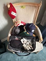 Chair displaying entire lot: caps, headcover, cooler, gloves