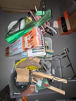 Overview of tote with boxed sweater dryers, hangers, bins, tools