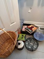 group shot showing basket, polka dot glassware, stainless candle, green Decora box, books, bowl, metal votive holder