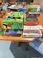 Overall view of stacked games and puzzles on table