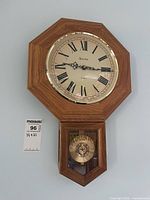Full view of Bulova regulator wall clock on wall