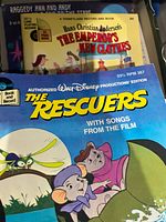 Cover artwork of The Rescuers and The Emperor’s New Clothes book-and-record sets visible in box