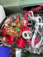 Bag of assorted ornaments including reindeer, panda, candy cane, red balls