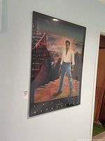 Framed Elvis Presley poster hanging on wall, full view