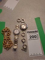 Group shot of ESQ wristwatch, pendant watch and three bracelets