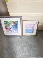 Both framed prints side by side on floor