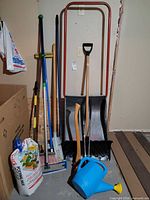 Group shot of all yard tools and supplies leaning against wall