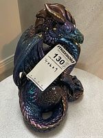 Full view of dragon figurine showing iridescent coloring and overall form