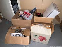 Four cardboard boxes with assorted holiday contents