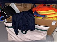 Canvas storage bag, box containing life jackets and garments