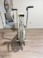 Front view of Johnson air fan exercise bike showing fan wheel, handlebars, console, and pedals