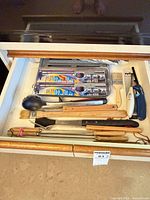 Drawer view with majority of utensils and loose lighters