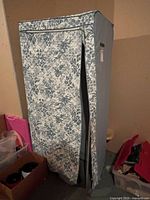 Full exterior view of light blue quilted fabric wardrobe