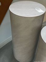 Full view of cylindrical faux concrete pedestal