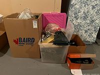 Overview of cardboard box, clear tote, shoe box with lanterns