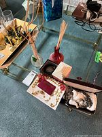 Overall view showing jewelry, rosary, brooch, bracelet, two glass vases