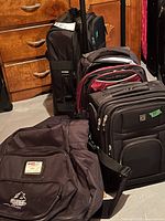 Group shot of all four luggage pieces standing on floor