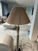 Full view of floor lamp with pleated shade and brushed nickel column