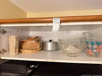 Shelf view of mixed kitchenware items