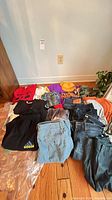 Overview of all clothing items spread on floor