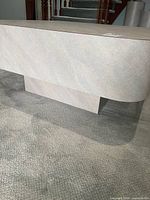 square beige-gray laminate coffee table on carpet