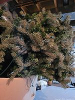 Boxed sections of artificial tree showing mixed green and brown-tipped needles