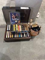 Overall lot showing cassette box with tapes, VHS, jug