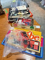 Stacked board game boxes with loose parts in view