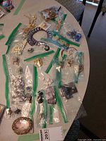 Overview of bagged costume jewellery spread on table