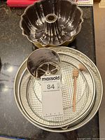Group shot of Bundt pan, springform pan pieces, flour sifter, honey dipper