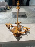 Full view of wood airplane mobile showing base, spindle and suspended planes