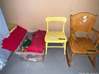 Yellow chair, rocking chair, plastic bin with lid