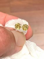 Close-up of both tourmaline studs showing color and cut