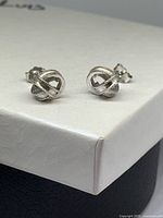 Front view of both silver knot studs on box lid