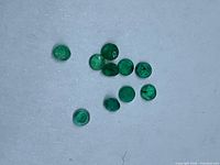 All 10 round emeralds on neutral background