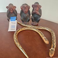 Group shot: three monkeys and two snakes